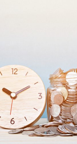 Wooden Alarm Clock And Coins On White Background