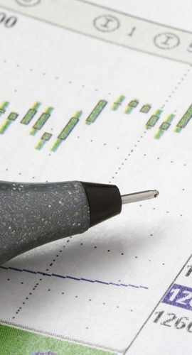 Close Up Shot Of Pen On Stock Chart
