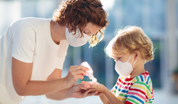 Mother And Child With Face Mask And Hand Sanitizer